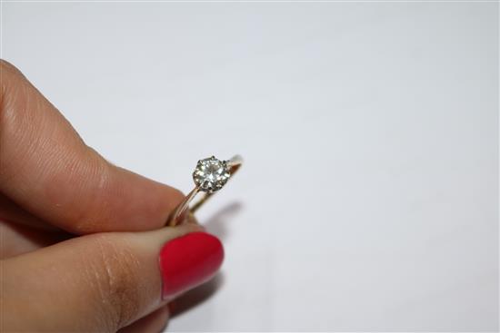 An 18ct gold, platinum and solitaire diamond ring, size M.